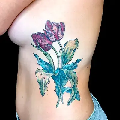 Colorful rib tattoo of tulips with painterly shading by Ruby Gore, female tattoo artist portland