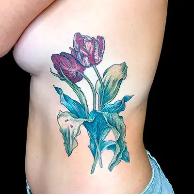 Colorful rib tattoo of tulips with painterly shading by Ruby Gore, nature tattoo artist portland
