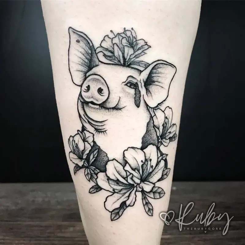 Fine line pig tattoo with flowers tattoo on calf, illustrative style with floral elements